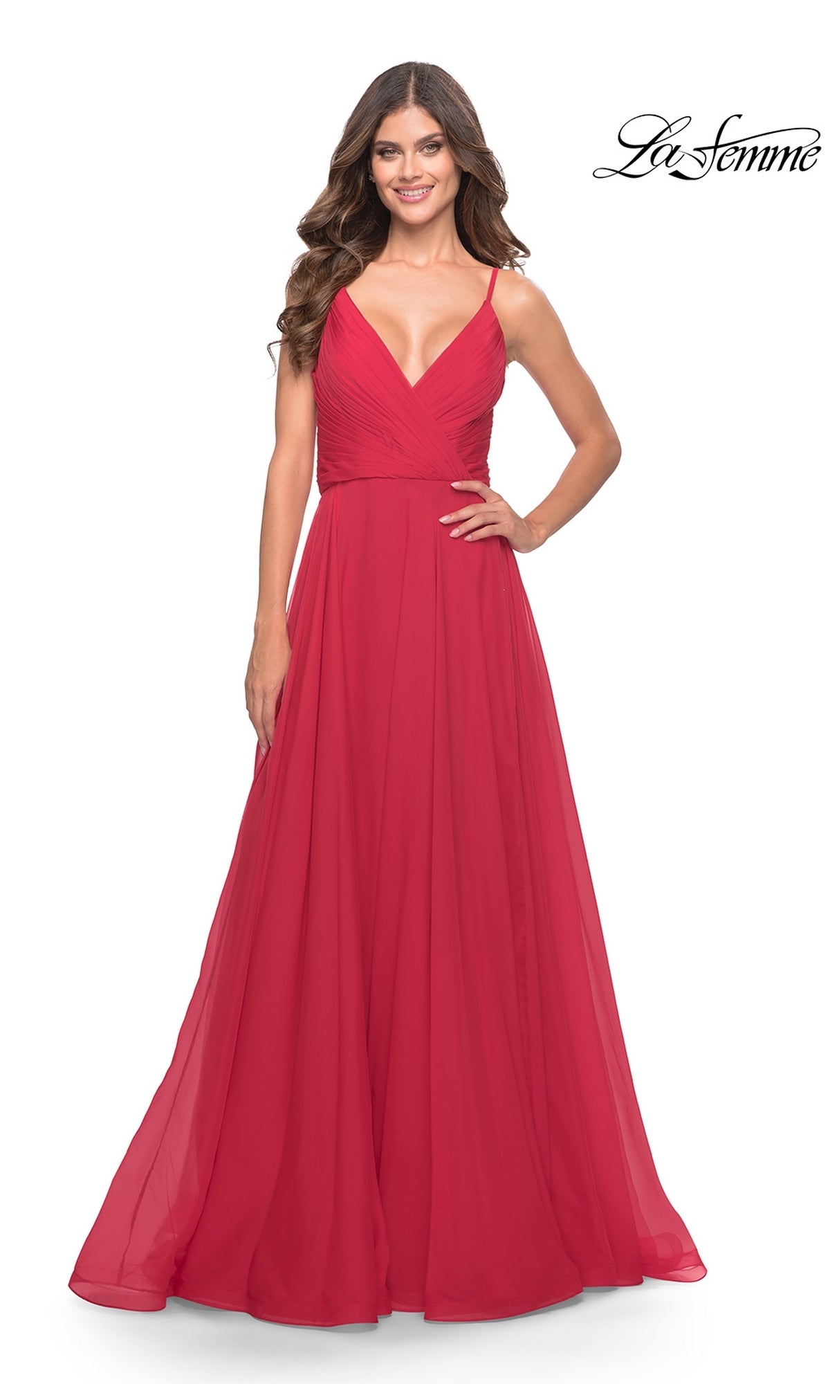 A woman smiles while wearing the La Femme V-Neck Long A-Line Prom Dress 31500, a sleeveless, floor-length red gown with spaghetti straps and a V-neckline. The La Femme logo appears in the top right corner.